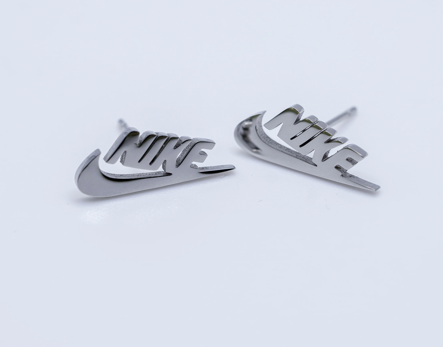 Pendientes Mini Swoosh y letras Nike plata